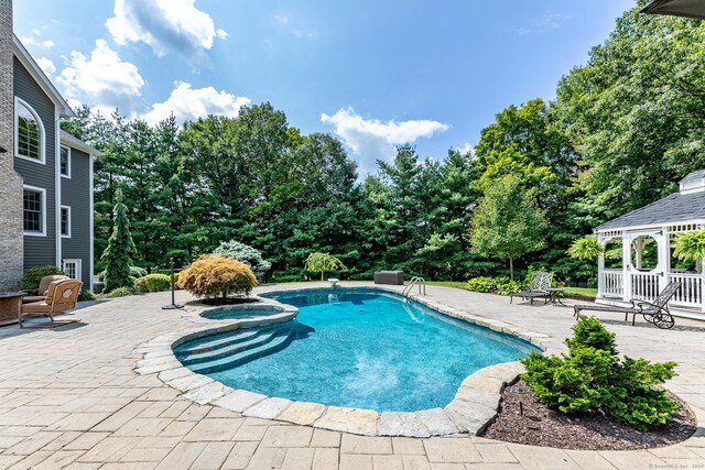 view of pool with a gazebo, a patio area, and an in ground hot tub