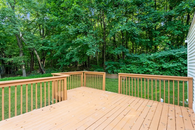 wooden deck featuring a lawn