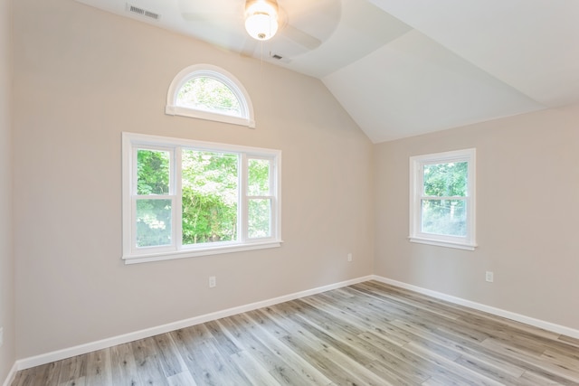 spare room with plenty of natural light, ceiling fan, and light hardwood / wood-style flooring