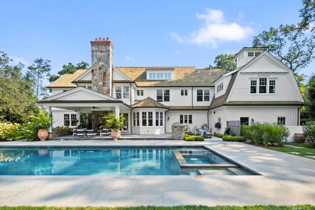 29 Sturges Commons, Westport, CT 06880 - rear view of house featuring a patio, ceiling fan, a chimney, and a pool with connected hot tub