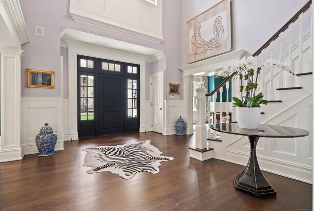 29 Sturges Commons, Westport, CT 06880 - foyer featuring ornate columns, stairs, a decorative wall, visible vents, and a towering ceiling