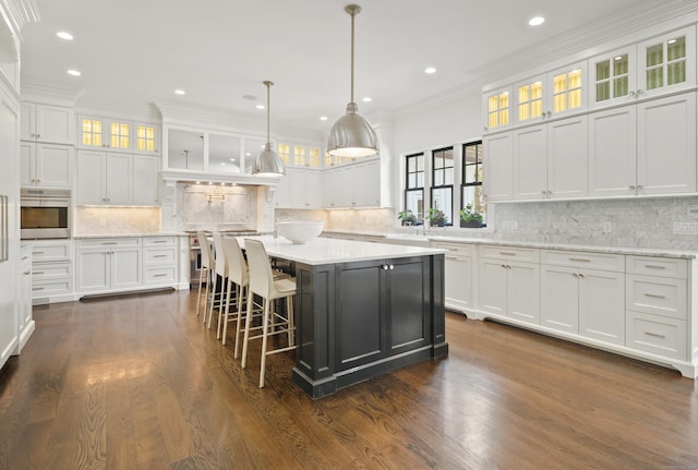 29 Sturges Commons, Westport, CT 06880 - kitchen with oven, white cabinetry, and tasteful backsplash