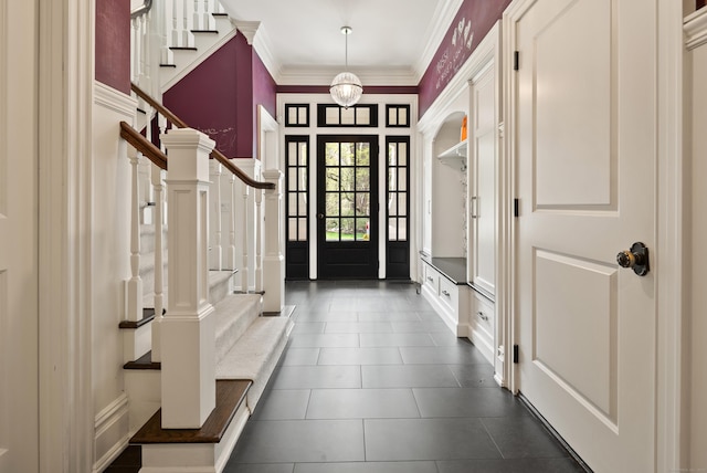 29 Sturges Commons, Westport, CT 06880 - mudroom featuring dark tile patterned floors, ornamental molding, and a decorative wall