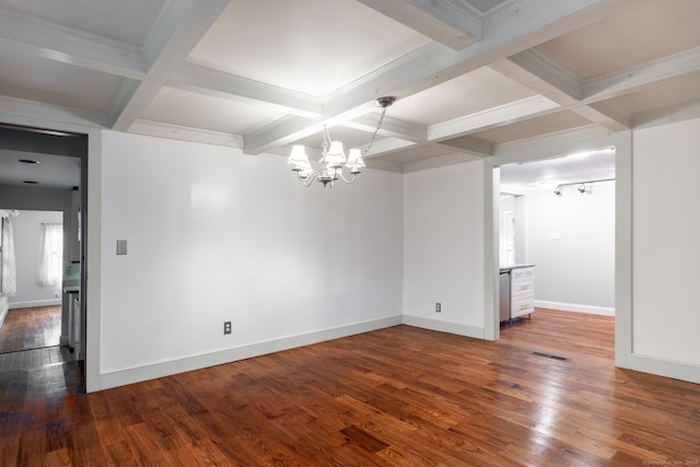 empty room with hardwood / wood-style floors, coffered ceiling, beamed ceiling, a notable chandelier, and ornamental molding