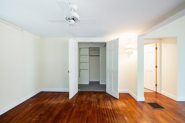 unfurnished bedroom featuring a closet, ceiling fan, and dark hardwood / wood-style floors