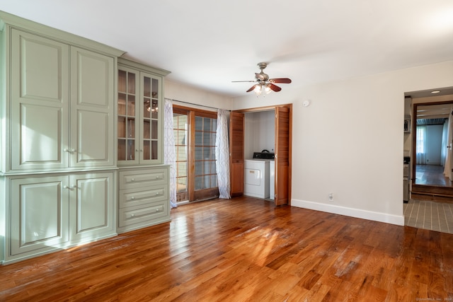 unfurnished room featuring washer / dryer, hardwood / wood-style flooring, and ceiling fan