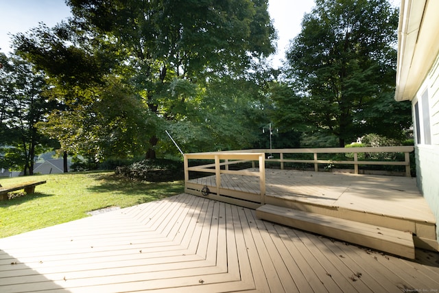 wooden terrace featuring a lawn