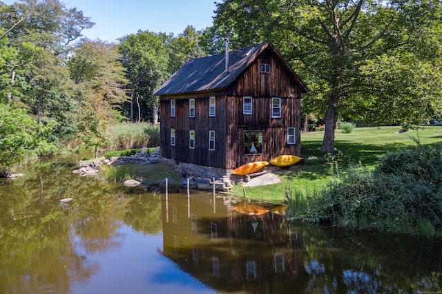 back of house featuring a water view