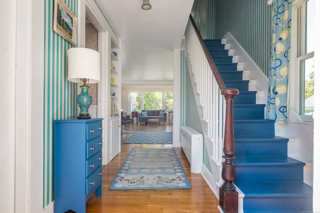 entrance foyer with radiator and hardwood / wood-style flooring