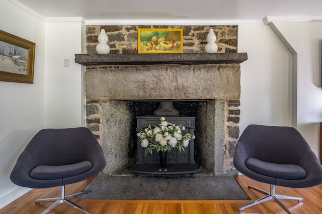 room details featuring crown molding, a premium fireplace, and wood-type flooring