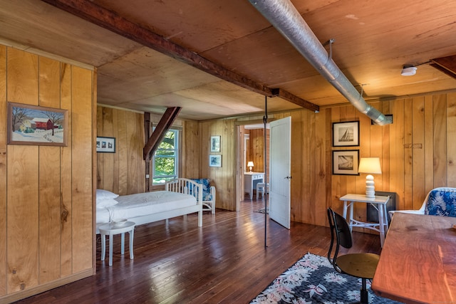 bedroom with wood ceiling, dark hardwood / wood-style floors, beam ceiling, and wooden walls