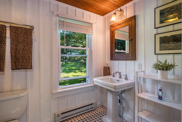 bathroom featuring wood walls, wooden ceiling, toilet, tile patterned floors, and a baseboard heating unit