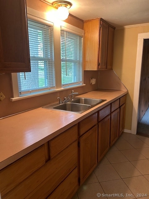 kitchen featuring sink and light tile patterned flooring