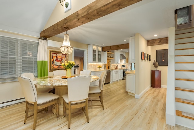 dining space featuring baseboard heating, lofted ceiling, sink, a chandelier, and light wood-type flooring