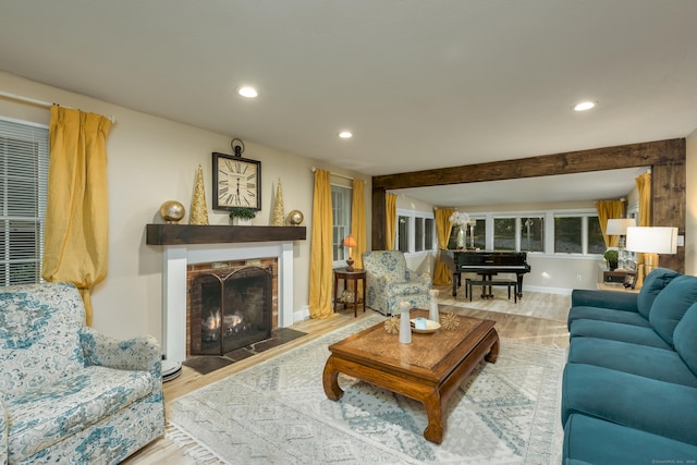 living room with light hardwood / wood-style floors and beamed ceiling