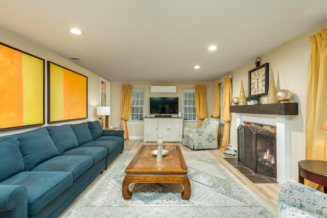 living room featuring light hardwood / wood-style flooring and a tile fireplace