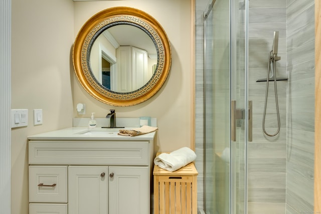 bathroom with a shower with shower door and vanity