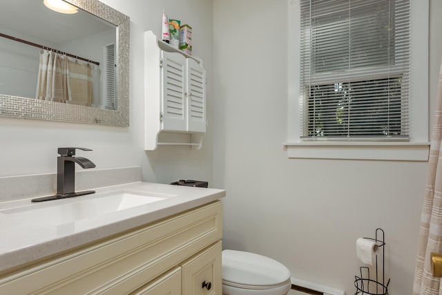 bathroom with vanity, toilet, and a baseboard radiator