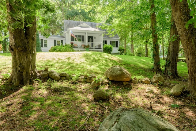 view of yard with covered porch