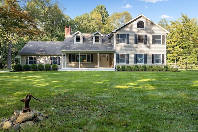 14 Stilson Ln, New Milford, CT 06776 - view of front of house featuring a front lawn, fence, covered porch, and a chimney