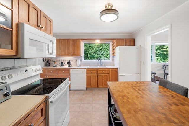 14 Stilson Ln, New Milford, CT 06776 - kitchen with white appliances, brown cabinetry, butcher block counters, a sink, and decorative backsplash