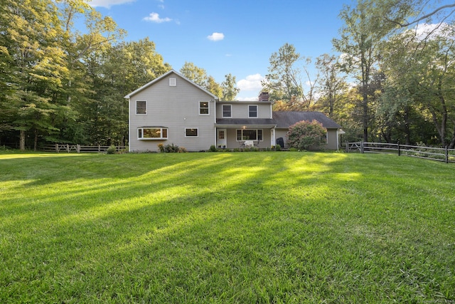 14 Stilson Ln, New Milford, CT 06776 - rear view of house featuring fence, a chimney, and a lawn