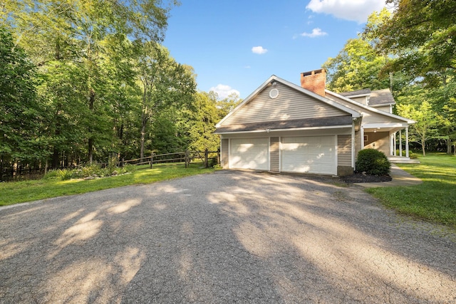 14 Stilson Ln, New Milford, CT 06776 - view of property exterior with an attached garage, a lawn, a chimney, fence, and driveway