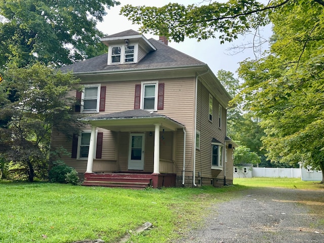 view of front of home with a front yard and covered porch