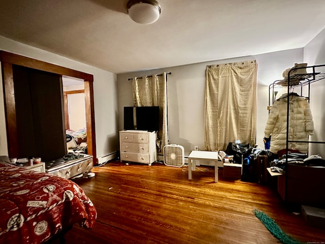 interior space with a baseboard radiator and hardwood / wood-style flooring