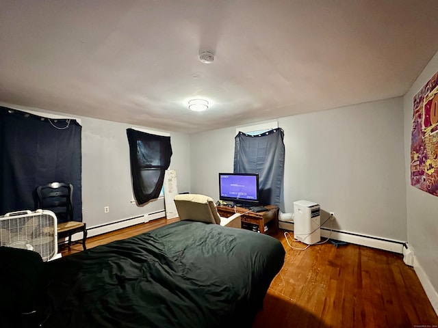 bedroom featuring wood-type flooring and baseboard heating