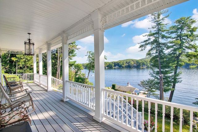 deck with a water view and a porch