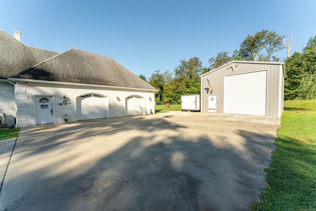 view of home's exterior with a garage and an outdoor structure