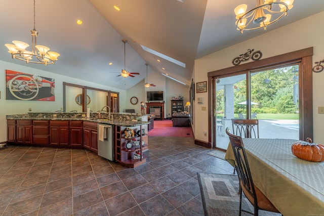 kitchen featuring dishwasher, pendant lighting, ceiling fan with notable chandelier, and high vaulted ceiling