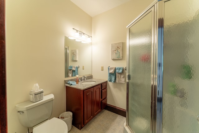 bathroom featuring an enclosed shower, toilet, and vanity