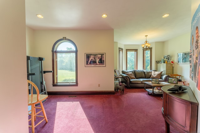 living room with carpet flooring and an inviting chandelier