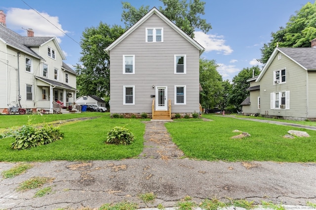 front facade with a front yard