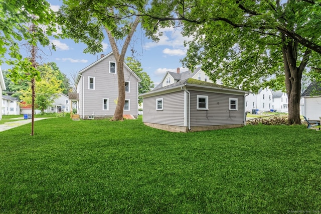 back of house with a lawn