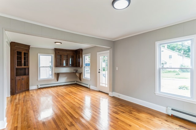 unfurnished living room featuring light wood-type flooring, a baseboard radiator, and ornamental molding