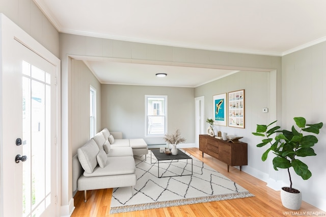 living room featuring a wealth of natural light, light hardwood / wood-style floors, and ornamental molding