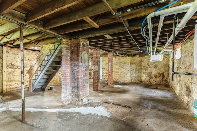 basement featuring brick wall