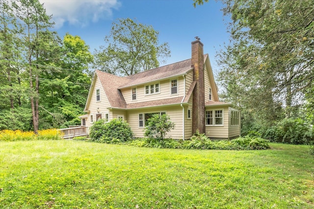 175 Sugar St, Newtown, CT 06470 - rear view of property featuring a chimney, a wooden deck, roof with shingles, and a yard