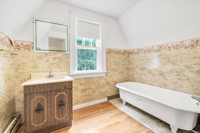 175 Sugar St, Newtown, CT 06470 - full bathroom with vanity, wood finished floors, a soaking tub, lofted ceiling, and a baseboard heating unit