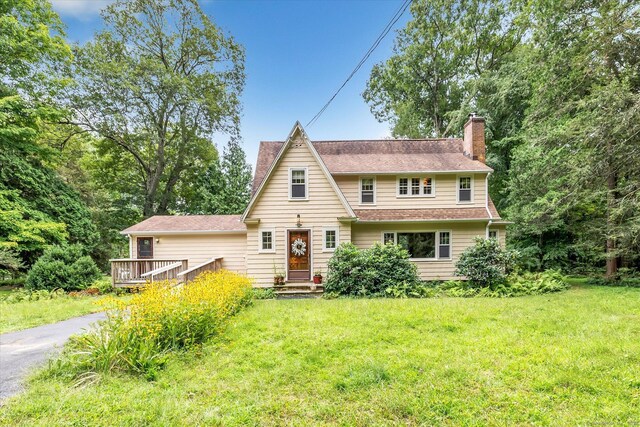 175 Sugar St, Newtown, CT 06470 - view of front of home featuring a wooden deck, a chimney, roof with shingles, and a front lawn