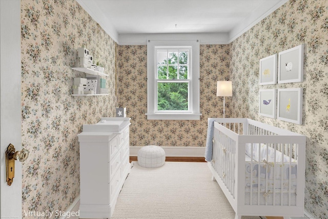 175 Sugar St, Newtown, CT 06470 - bedroom featuring baseboards, wallpapered walls, a sink, a crib, and wood finished floors