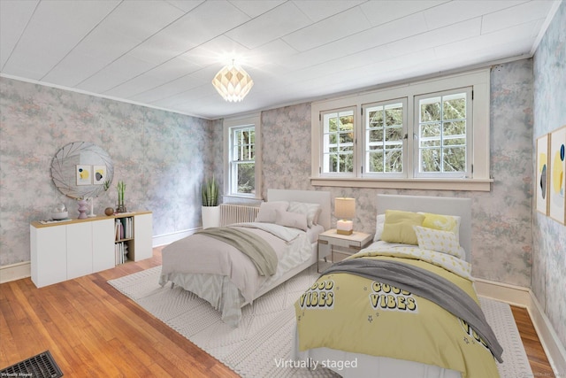 175 Sugar St, Newtown, CT 06470 - bedroom with hardwood / wood-style floors, wallpapered walls, radiator, and visible vents