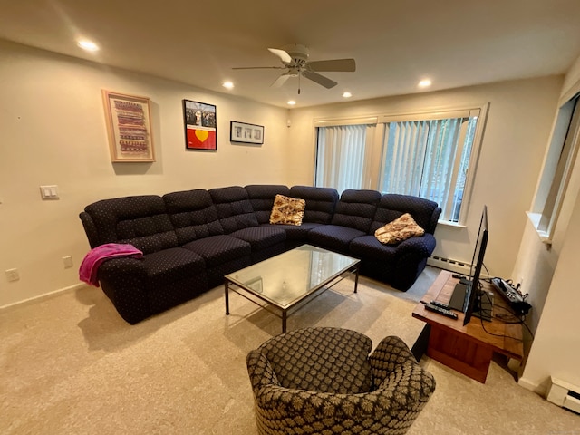 living room featuring light colored carpet, baseboard heating, and ceiling fan