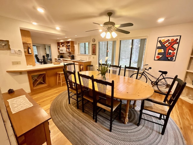 dining space with light wood-style floors, ceiling fan, and recessed lighting