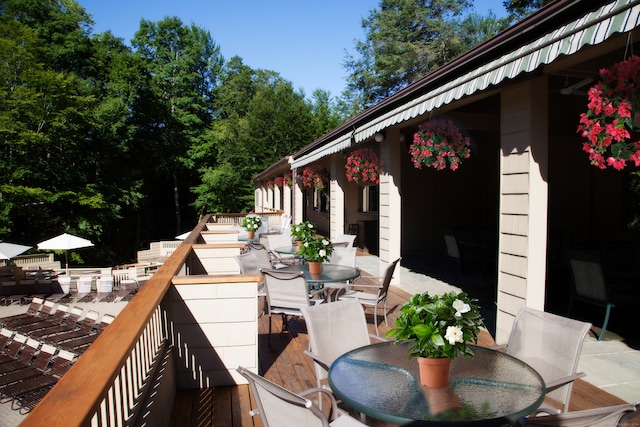 wooden terrace featuring outdoor dining space