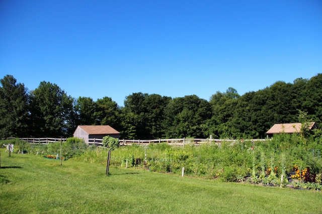 view of yard with fence and a forest view