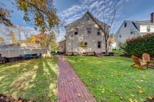 rear view of property featuring a yard